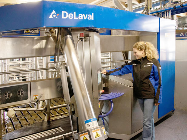 Woman operating DeLaval VMS